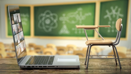 student desk in front of laptop